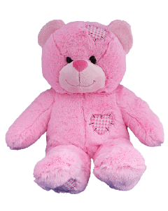 An adorable pink patches fluffy teddy bear with a heart shaped patch on its head, tummy and one foot