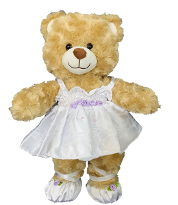 Cute white ballerina dress with purple flowers and ballet shoes on a nice light brown bear