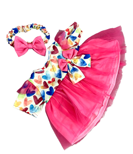 pink dress with a top in white with colorful hearts and a headband with a pink bowtie