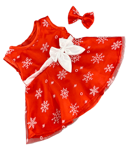 Red dress with white snowflakes printed on it, with white belt with a white bow and a small red bow for the hair