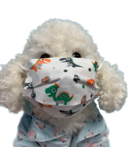 White face mask with dinos on a white poodle plush toy dog